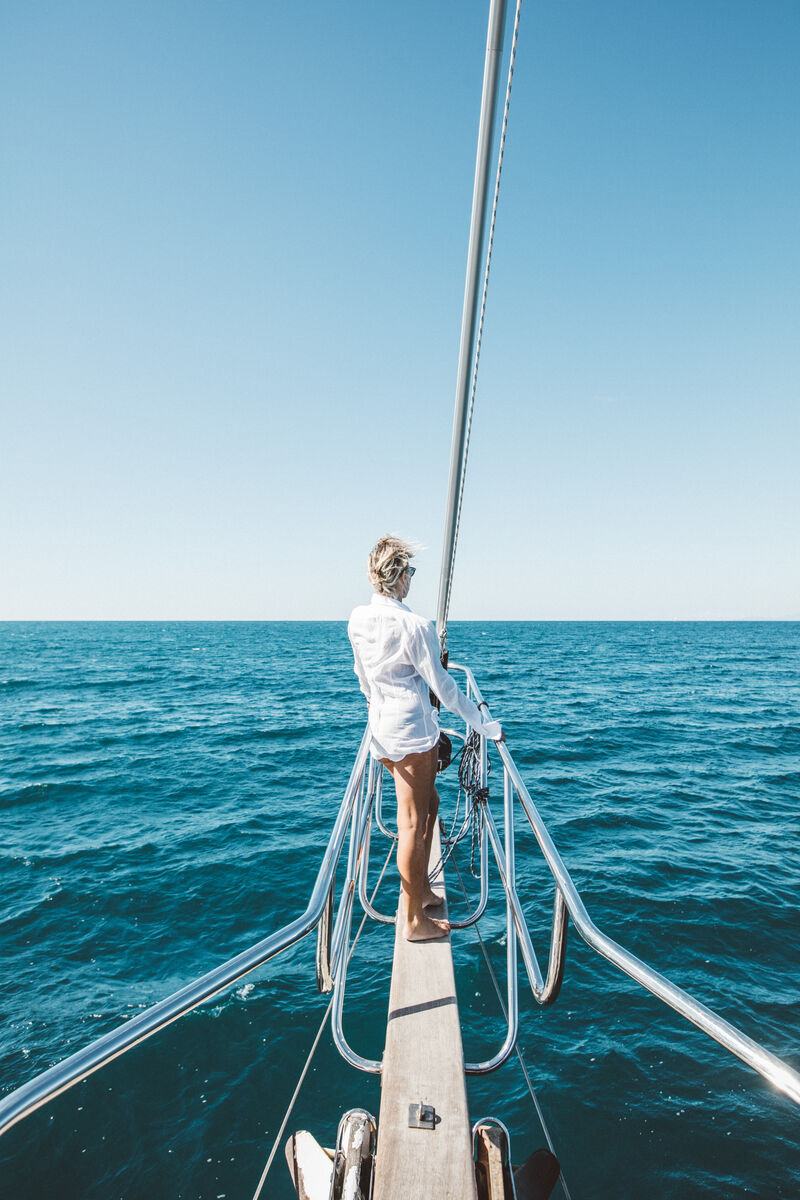 A guest standing on the bowsprit looking out to sea
