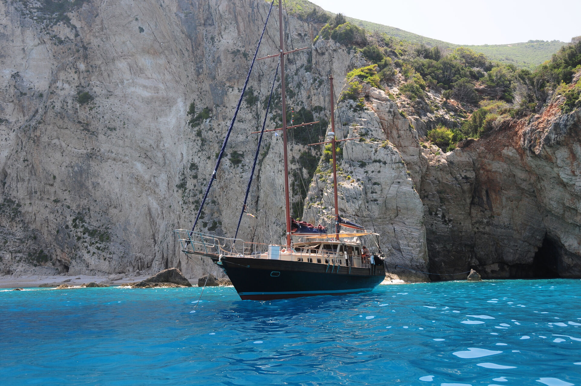 Sea Moon anchored in a bay flanked by towering limestone cliffs