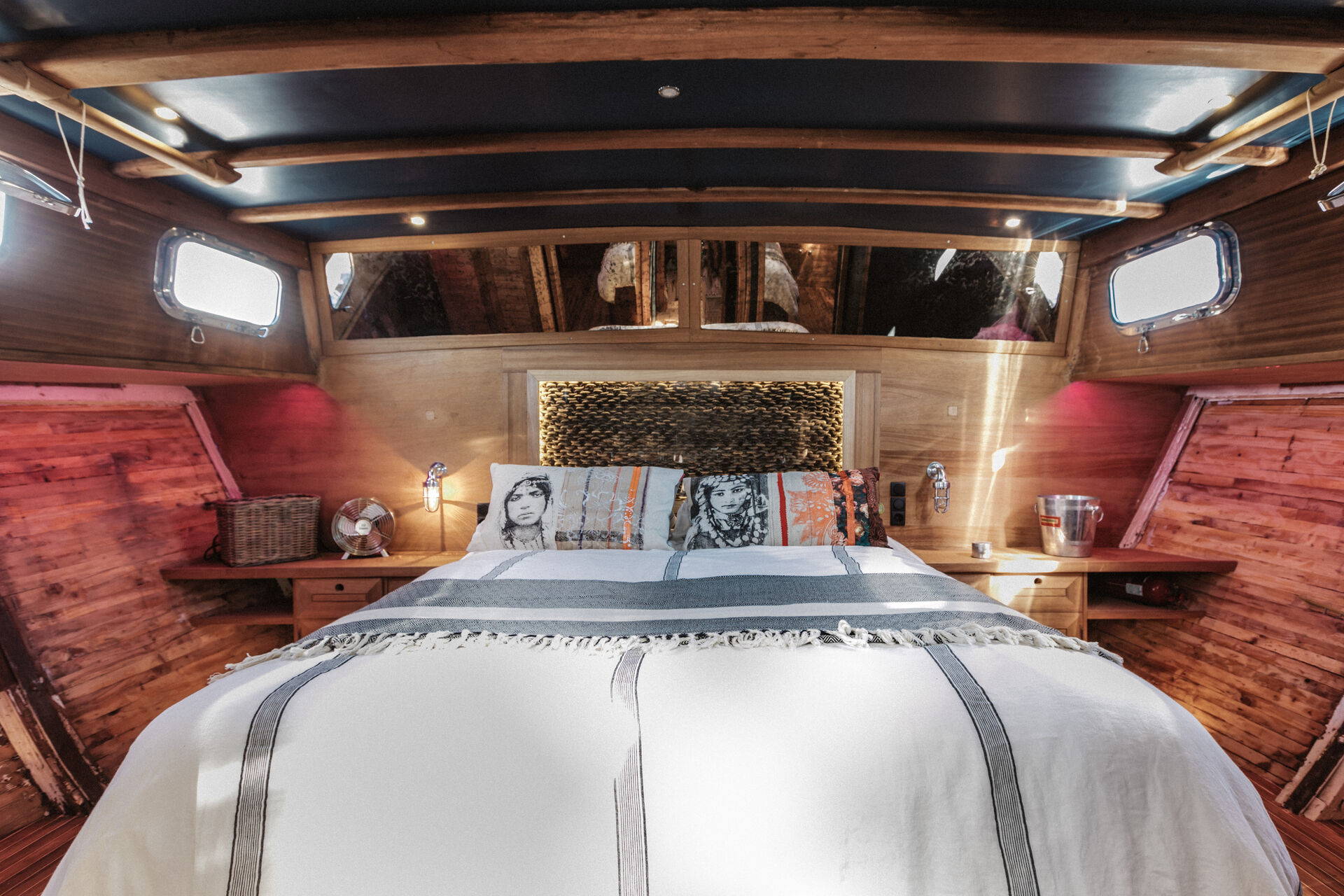 Master cabin with king-size bed, exposed plank walls and lantern light