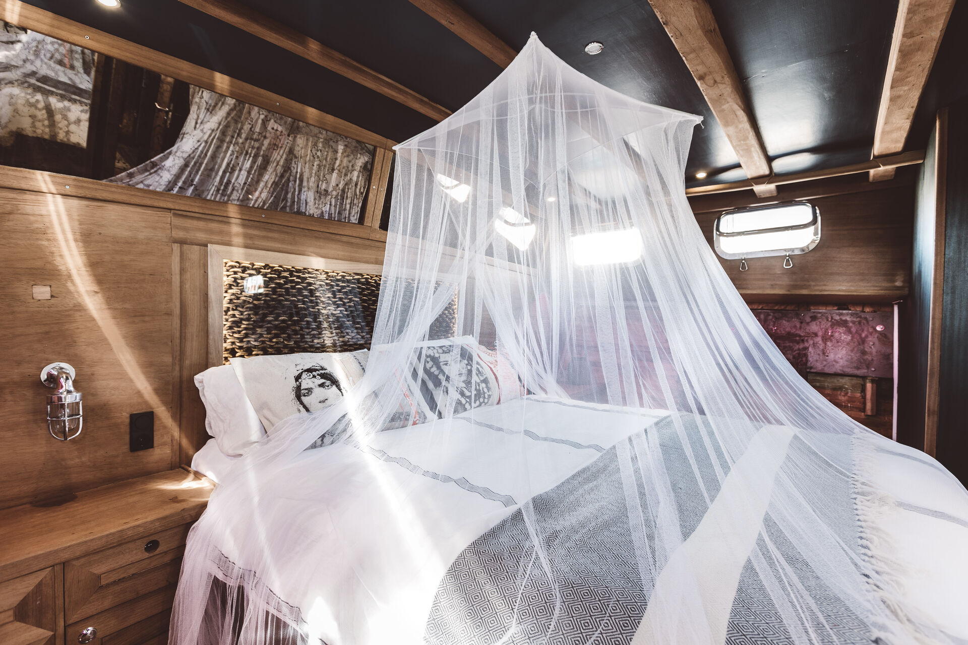 The Master Cabin with a sheer white canopy over the bed