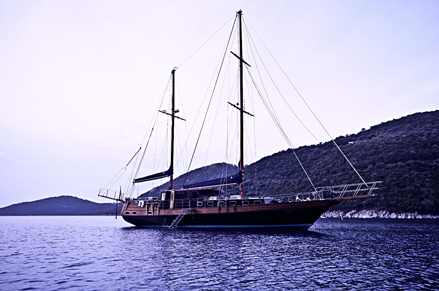 Sea Moon at rest in a quiet coastal bay in the Sporades